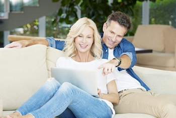 Couple looking at a screen on computer